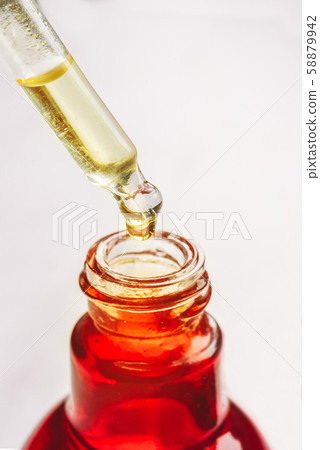 Drop of oil, serum in a dropper closeup. Skin care concept. 58879942
