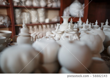 Making ceramic pots and cups from white clay Making ceramic pots and cups from white clay 58882143
