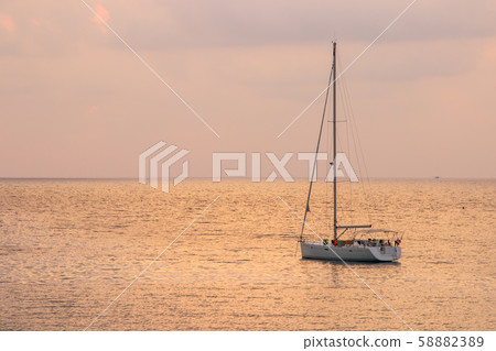 White sailboat of tourist at the background with sunset sky on the Ao thai sea area around haad bangbao of koh kood in trat province 58882389