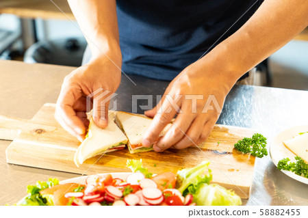Man making food in kitchen Man making food in kitchen 58882455