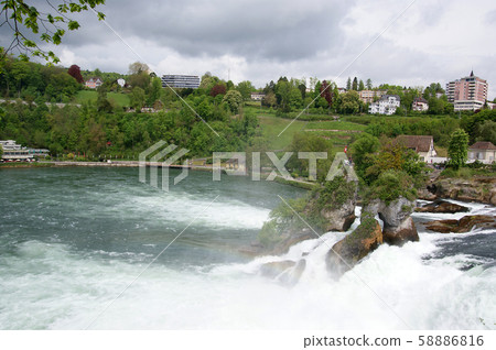 Waterfall Rhine Falls (Rheinfall) at Schaffhausen in Switzerland. The largest waterfall in Europe Waterfall Rhine Falls (Rheinfall) at Schaffhausen in Switzerland. The largest waterfall in Europe 58886816