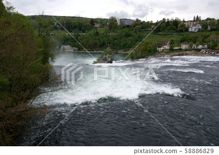 Waterfall Rhine Falls (Rheinfall) at Schaffhausen in Switzerland. The largest waterfall in Europe Waterfall Rhine Falls (Rheinfall) at Schaffhausen in Switzerland. The largest waterfall in Europe 58886829