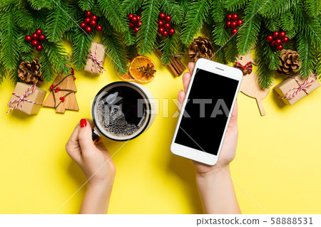 Top view of a woman holding a phone in one hand Top view of a woman holding a phone in one hand 58888531