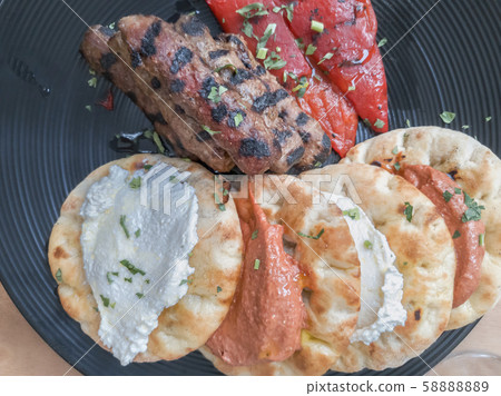 Greek shaped meatballs - soutzoukakia cooked. Greek shaped meatballs - soutzoukakia cooked. 58888889