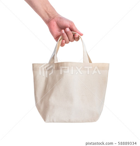 Tote bag canvas white cotton fabric cloth for eco shoulder shopping sack mockup blank template isolated on white background (clipping path) with woman hand handling handle straps 58889334