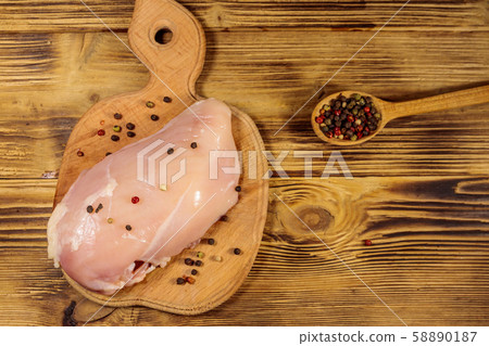Raw chicken breast on cutting board Raw chicken breast on cutting board 58890187