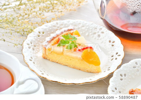 An image of tea and fruit tart tea time. 58890487