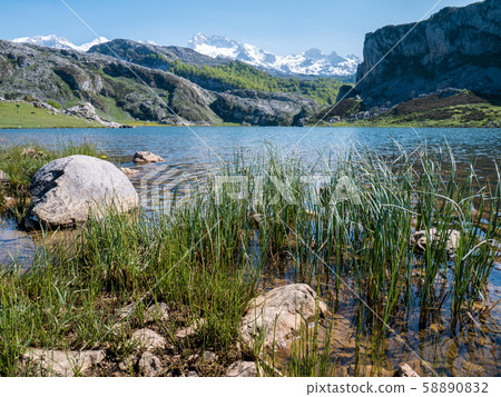Mountain lake and peaks covered with the snow. 58890832