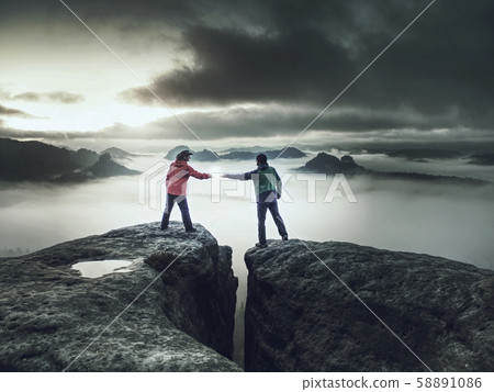 Girl is putting lightning lantern over rocky edge Girl is putting lightning lantern over rocky edge 58891086