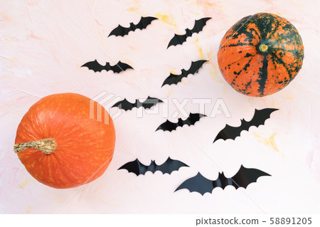 Pumpkins and bats on a pink background. Pumpkins and bats on a pink background. 58891205