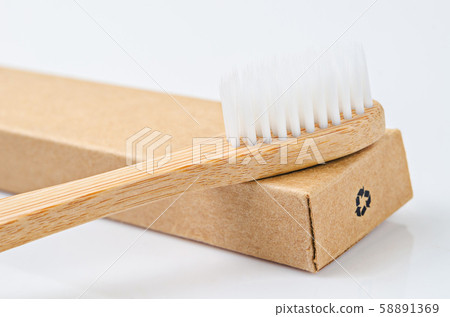 Bamboo toothbrushes on brown paper box with Bamboo toothbrushes on brown paper box with 58891369