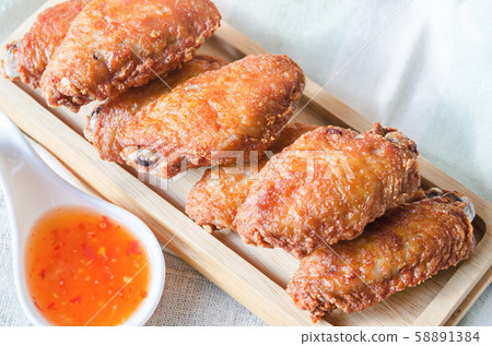 Fried chicken wing with chilli sauce. Fried chicken wing with chilli sauce. 58891384