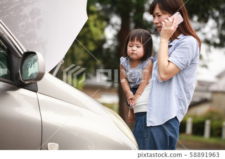 Mother and girl with broken car Mother and girl with broken car 58891963