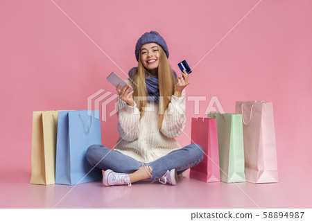 Pretty girl using phone and credit card for online shopping Pretty girl using phone and credit card for online shopping 58894987