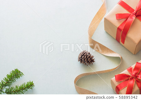 Christmas background with gift boxes, pine cone and decorations on light blue background. Preparation for holidays. Top view with copy space. 58895342