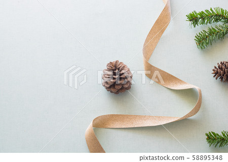 Christmas background with gift boxes, pine cone and decorations on light blue background. Preparation for holidays. Top view with copy space. 58895348