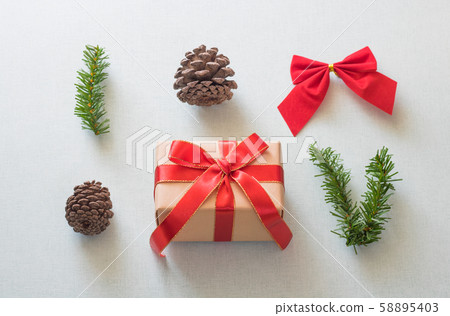 Christmas background with gift boxes, pine cone and decorations on light blue background. Preparation for holidays. Top view with copy space. 58895403