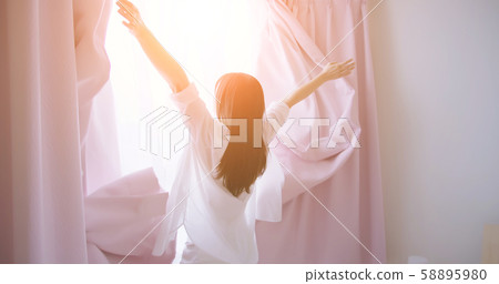 asian woman opening curtain asian woman opening curtain 58895980