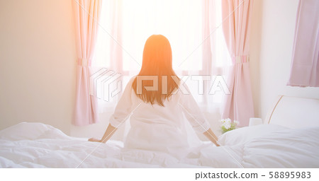 asian woman sit on bed 58895983
