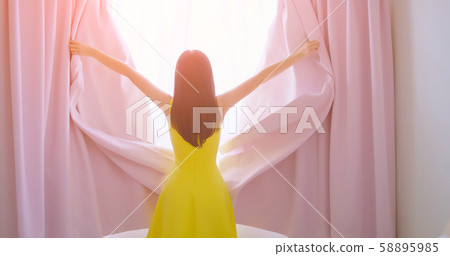 asian woman opening curtain 58895985