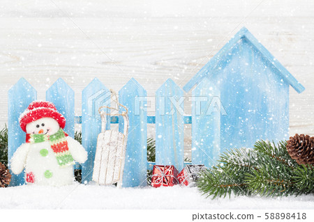 Christmas snowman toy, decor and fir tree branch Christmas snowman toy, decor and fir tree branch 58898418