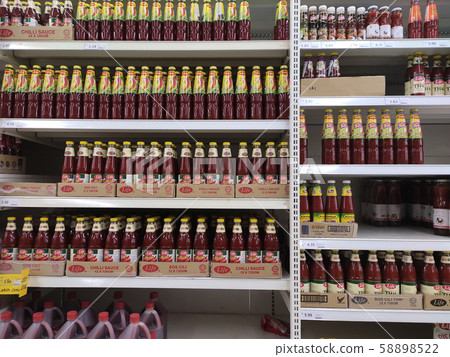 Selective focused variety of cooking sauce in the bottles displayed for sale in the supermarkets. Displayed on racks and separated by the brand to facilitate buyers. Selective focused variety of cooking sauce in the bottles displayed for sale in the supermarkets. Displayed on racks and separated by the brand to facilitate buyers. 58898522