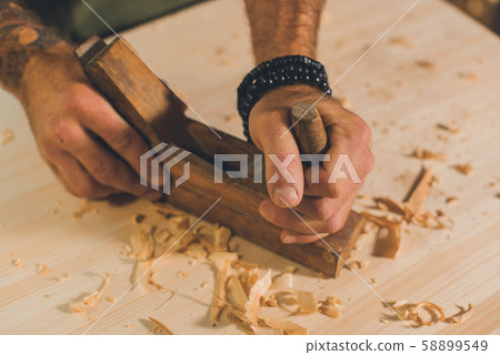 Portrait of a young male carpenter who works in his workshop. Portrait of a young male carpenter who works in his workshop. 58899549