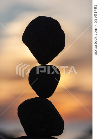 balanced stones on the beach at sunset balanced stones on the beach at sunset 58901493