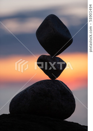 balanced stones on the beach at sunset balanced stones on the beach at sunset 58901494