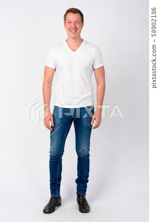 Full body shot of happy young handsome man smiling Full body shot of happy young handsome man smiling 58902186