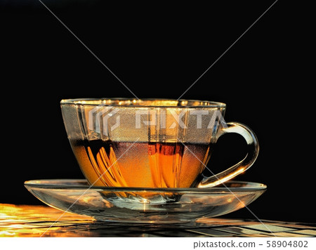 A Cup of freshly brewed black tea,escaping steam,warm soft light, darker background A Cup of freshly brewed black tea,escaping steam,warm soft light, darker background 58904802