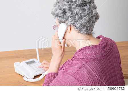 Elderly woman making a phone call 58906782