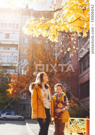 Smiling children brother and sister under sunny tree 58906842