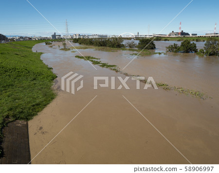 Arakawa flooded by a typhoon, Adachi-ku, Tokyo 58906997