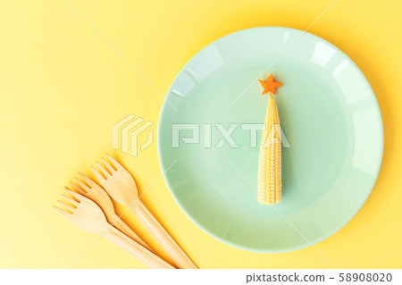 Funny edible Christmas tree from baby corn and carrot. Funny edible Christmas tree from baby corn and carrot. 58908020