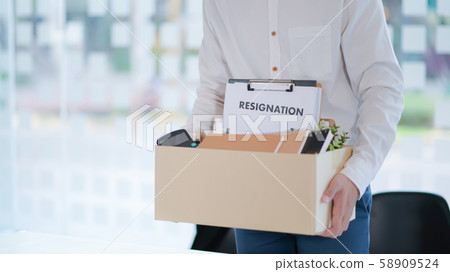 The office worker is packing things after resigning from work. The office worker is packing things after resigning from work. 58909524