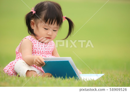 A girl reading a book A girl reading a book 58909526