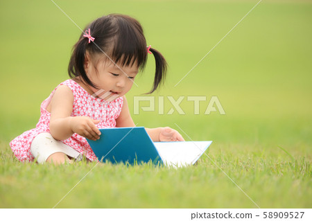 A girl reading a book A girl reading a book 58909527