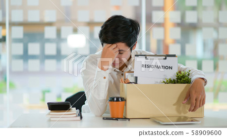 Concept resignation,Male employee with a storage box for equipment after resigning. 58909600
