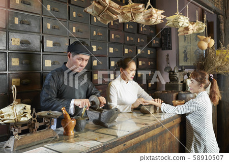 Woman attending old Chinese drugstore Woman attending old Chinese drugstore 58910507