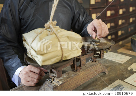 Traditional Asian apothecary worker weighting package Traditional Asian apothecary worker weighting package 58910679