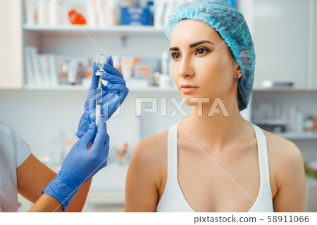 Cosmetician makes botox therapy to female patient Cosmetician makes botox therapy to female patient 58911066