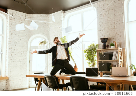 Businessman having fun dancing break dance in the office at work Businessman having fun dancing break dance in the office at work 58911665