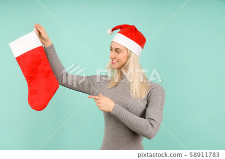A beautiful sexy girl in a New Year's hat and gray 58911783