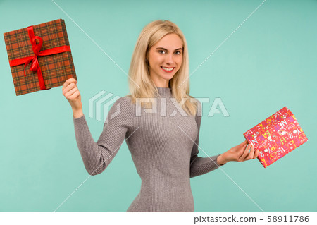 A beautiful smile woman in a gray dress, hold in 58911786