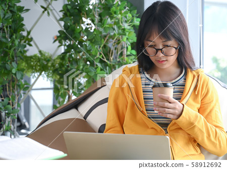 Asian female student wearing glasses is Asian female student wearing glasses is 58912692
