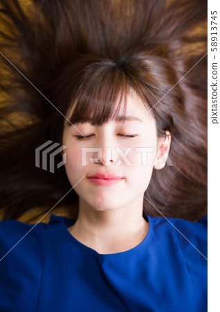 Young woman with long hair Young woman with long hair 58913745