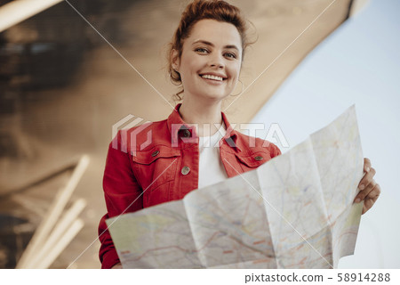 Smiling girl with map outdoors stock photo Smiling girl with map outdoors stock photo 58914288