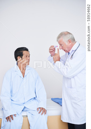 Ophthalmologist talking to senior patient 58914662