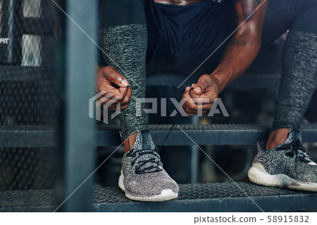 Sportsman tying laces Sportsman tying laces 58915832